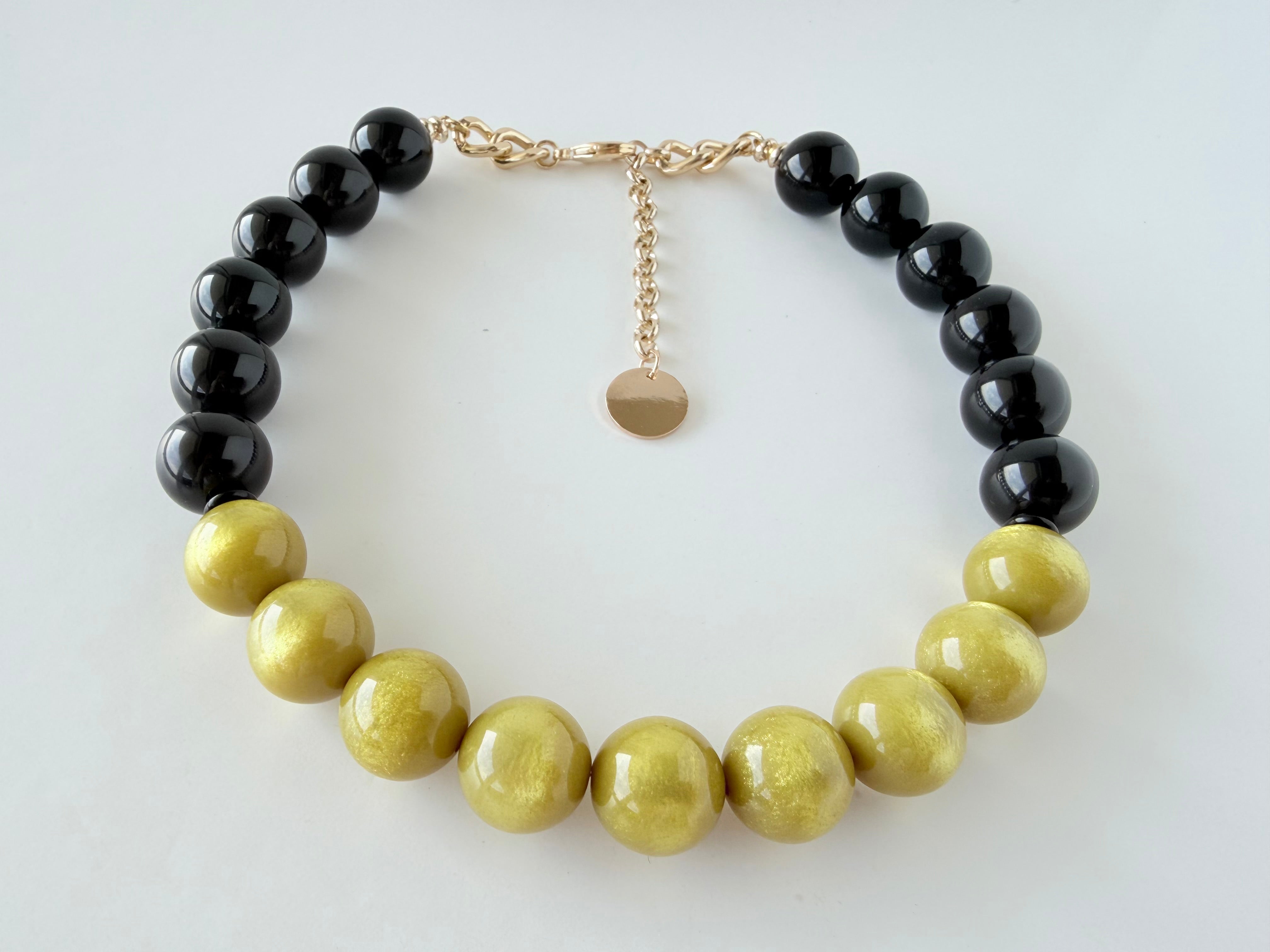 Handmade yellow mustard and black Italian resin statement necklace by Tessa Bijoux with glossy 18 mm beads.